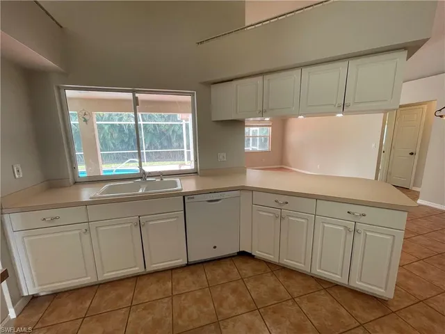 a kitchen with cabinets and window