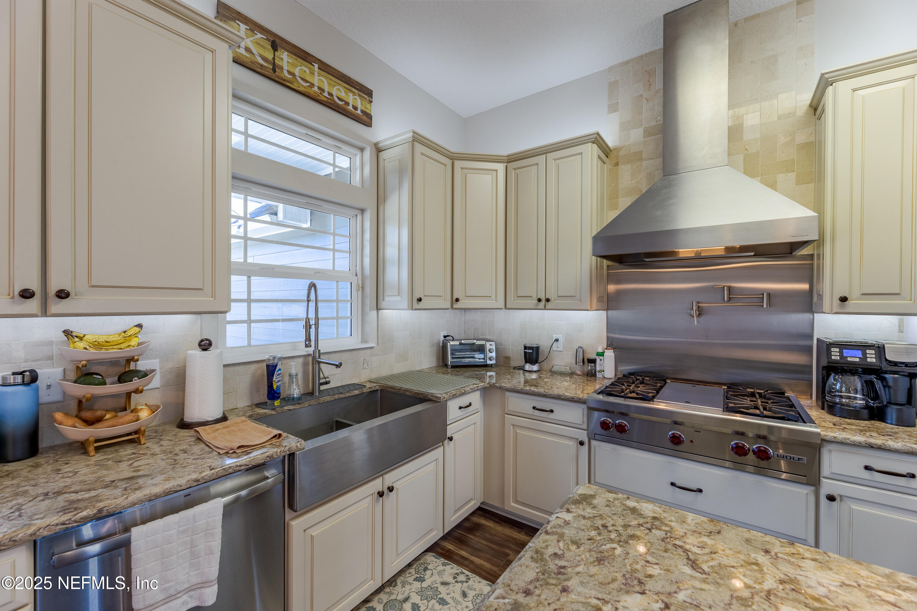 3670 Charles Green Road Hilliard, FL 32046 - Photo 24 of 68 a kitchen with stainless steel appliances granite countertop a sink stove and cabinets