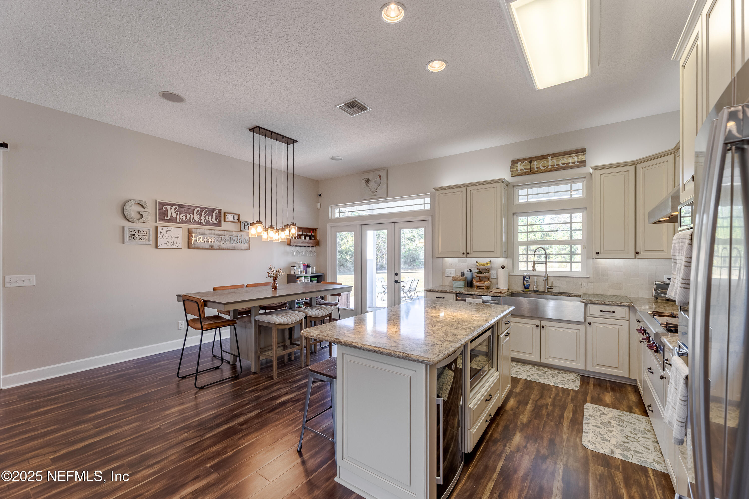 3670 Charles Green Road Hilliard, FL 32046 - Photo 25 of 68 a kitchen with a sink stove and wooden cabinets