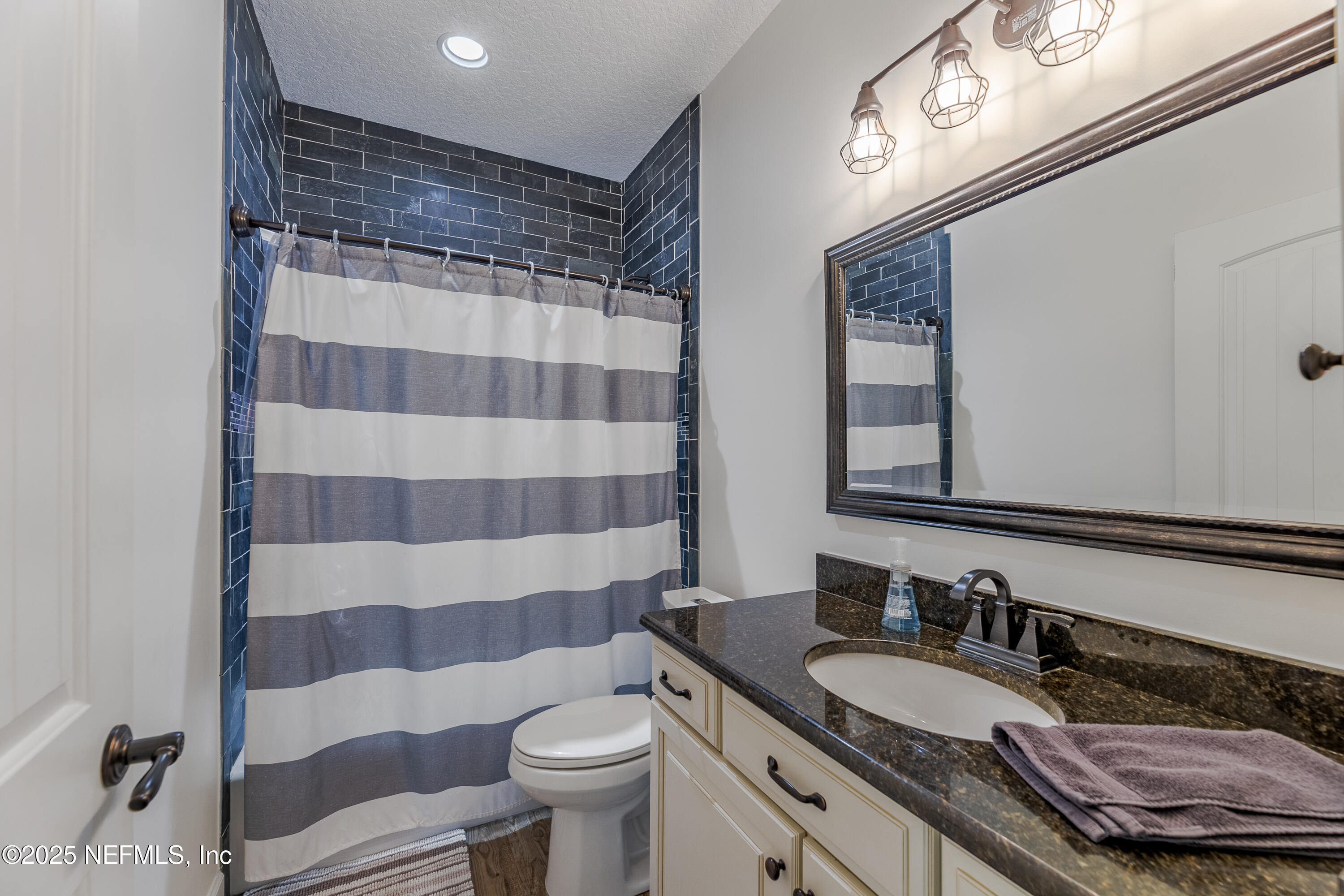 3670 Charles Green Road Hilliard, FL 32046 - Photo 28 of 68 a bathroom with a granite countertop sink and a mirror