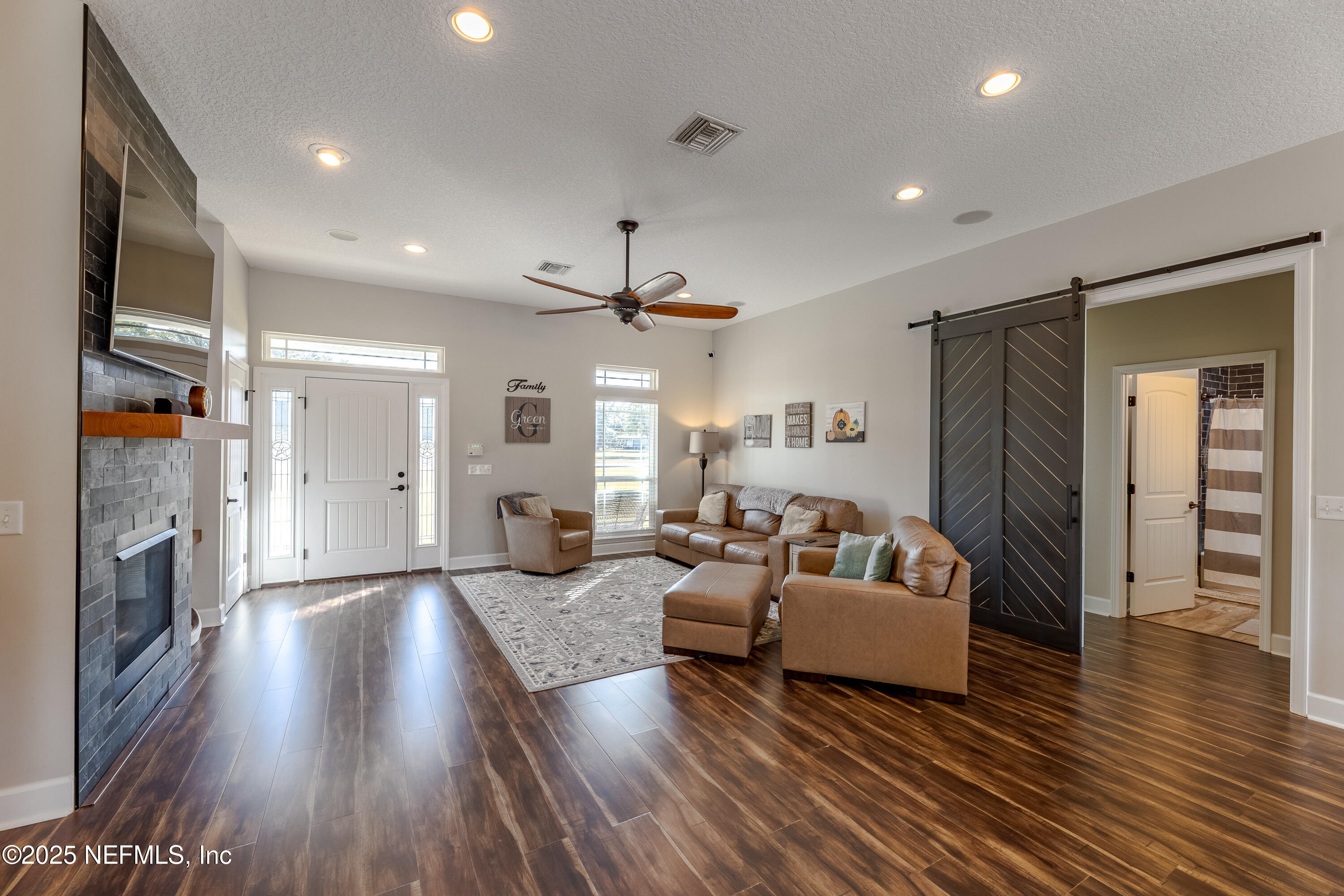 3670 Charles Green Road Hilliard, FL 32046 - Photo 3 of 68 a living room with furniture and a fireplace
