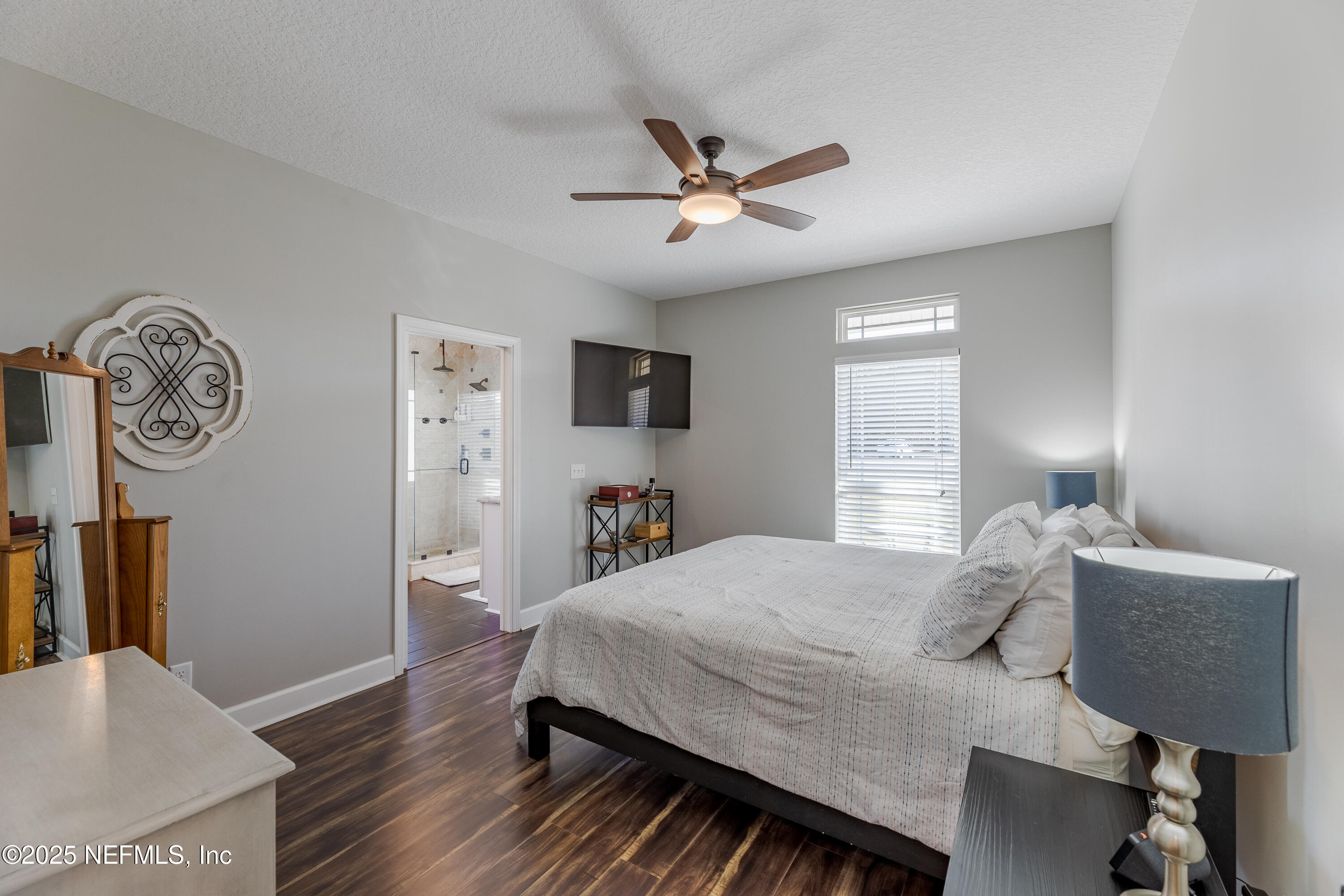3670 Charles Green Road Hilliard, FL 32046 - Photo 31 of 68 a bedroom with a bed a clock on the wall and dresser