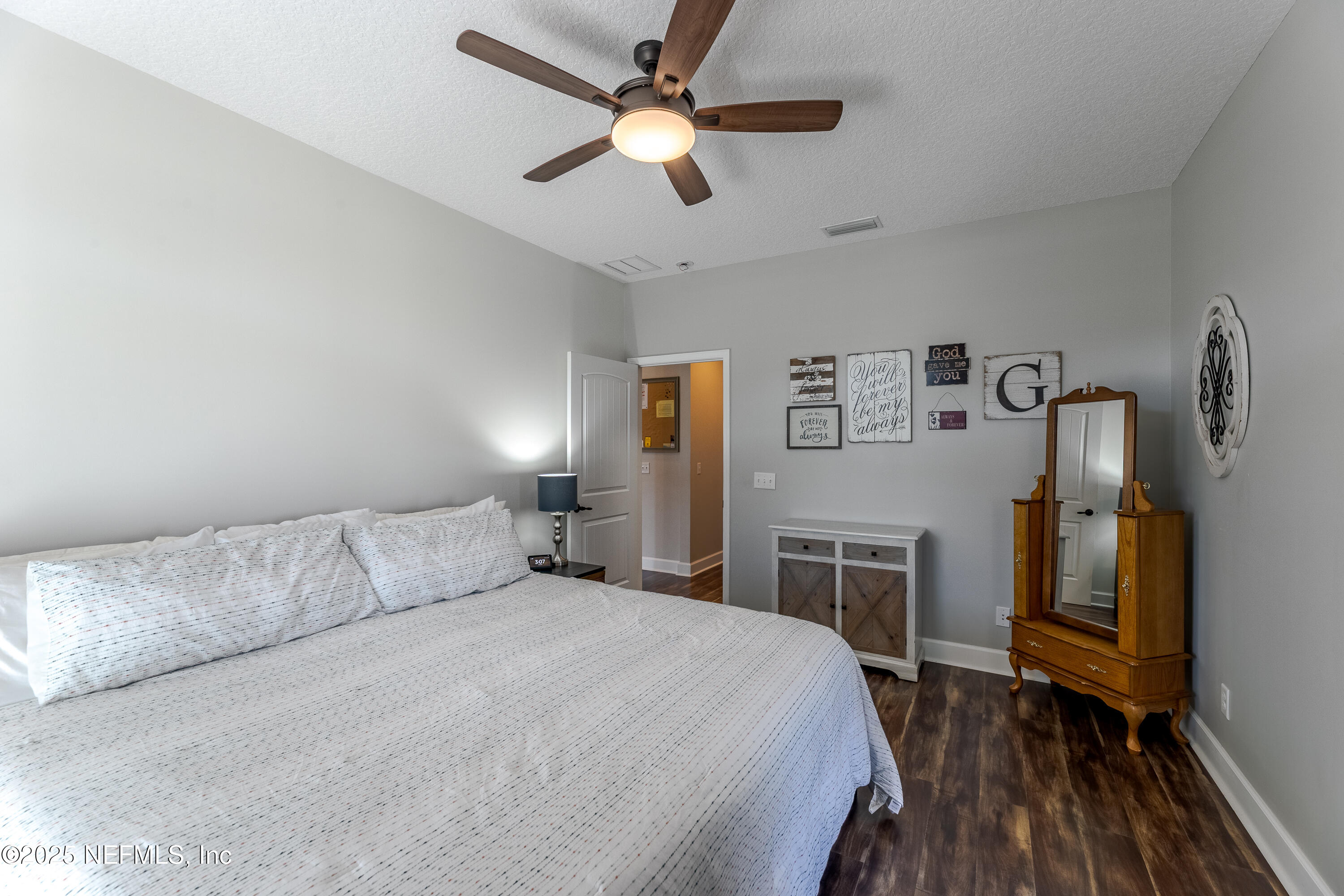 3670 Charles Green Road Hilliard, FL 32046 - Photo 33 of 68 a bedroom with a bed and a chandelier