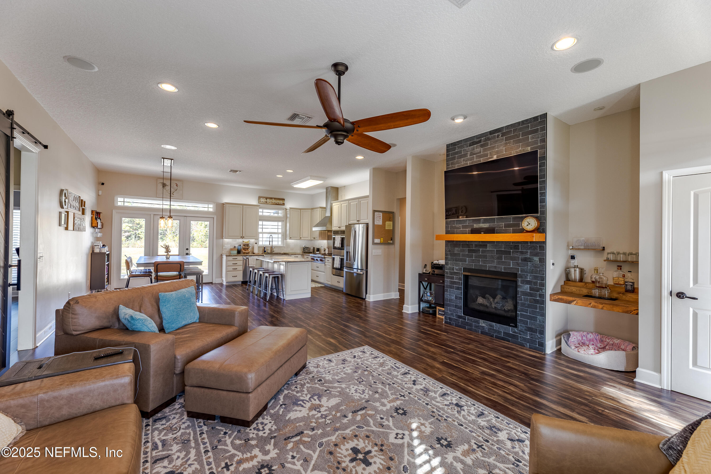3670 Charles Green Road Hilliard, FL 32046 - Photo 5 of 68 a living room with furniture flat screen tv and a fireplace