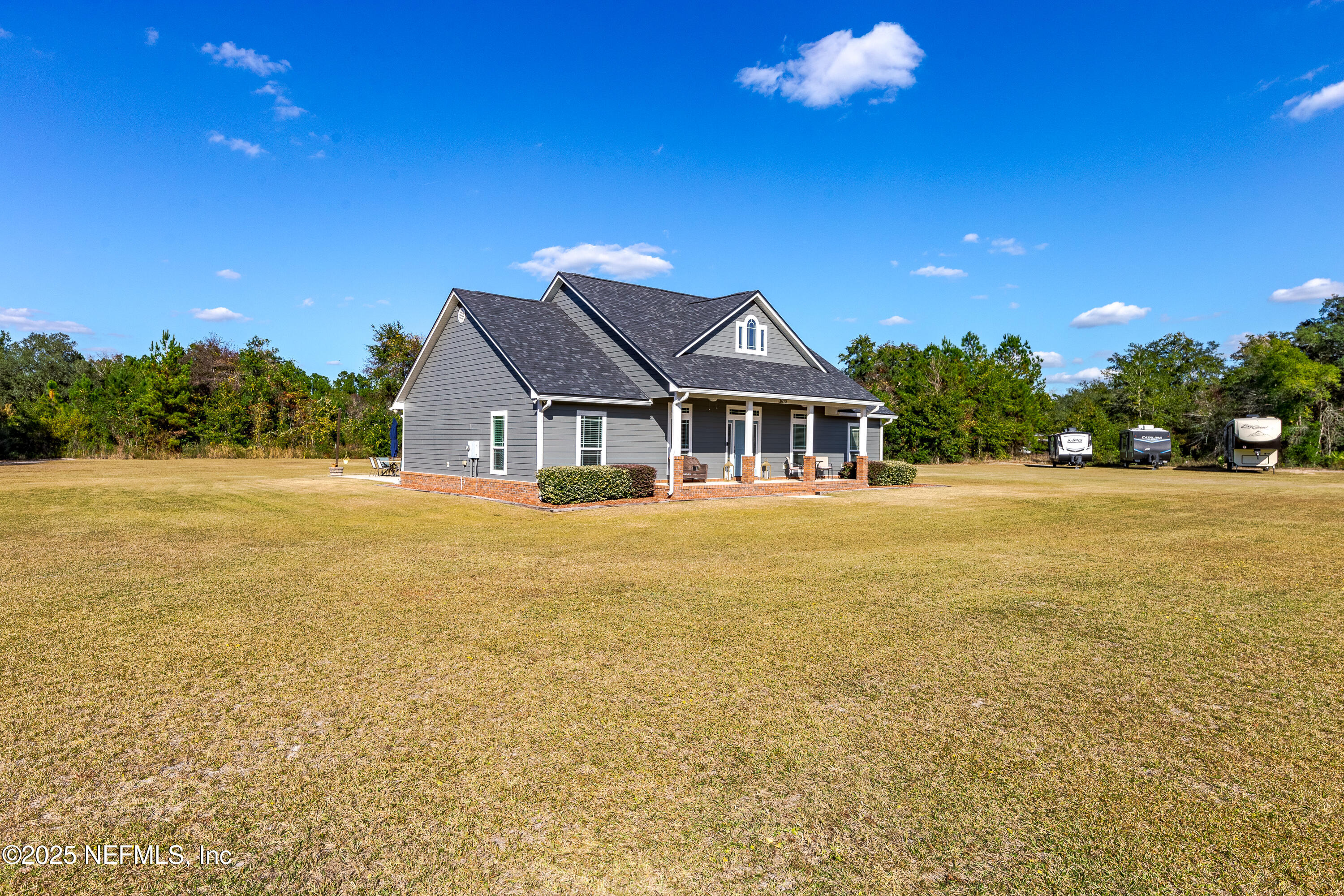 3670 Charles Green Road Hilliard, FL 32046 - Photo 62 of 68 a front view of a house with a yard