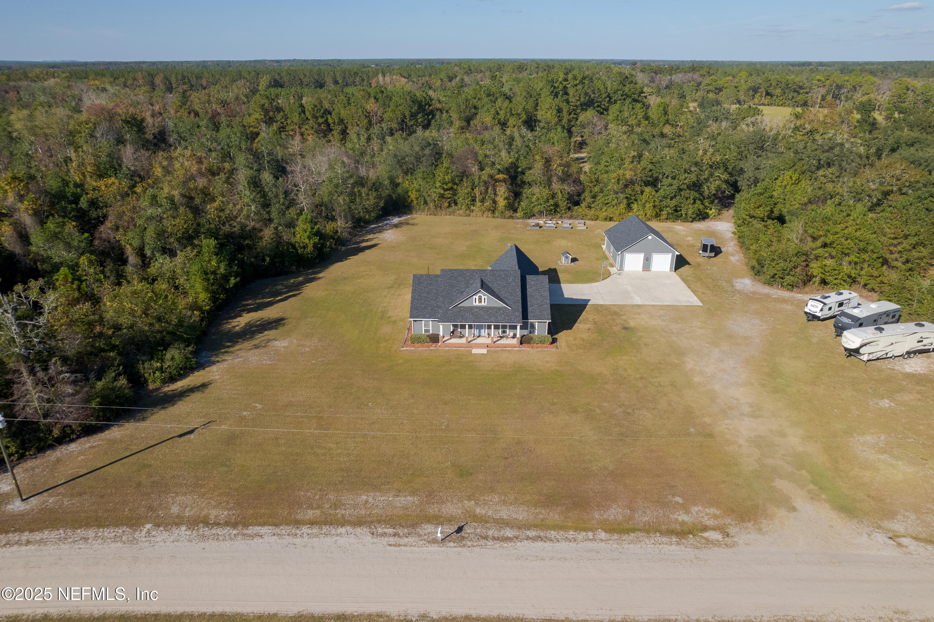3670 Charles Green Road Hilliard, FL 32046 - Photo 64 of 68 a view of a big yard with an outdoor space