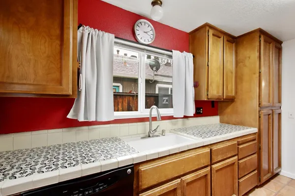 a kitchen with stainless steel appliances granite countertop a sink and a wooden cabinets