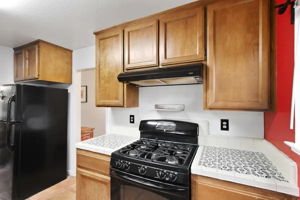 a kitchen with granite countertop stainless steel appliances and cabinets