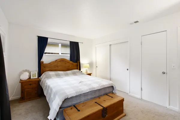 a bedroom with a bed and a night stand