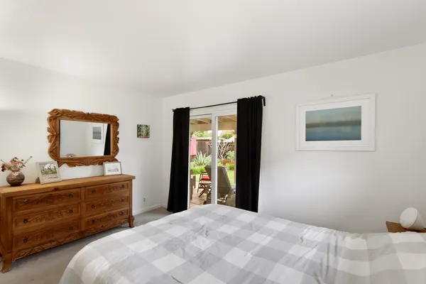 a bedroom with a bed and a dresser in it