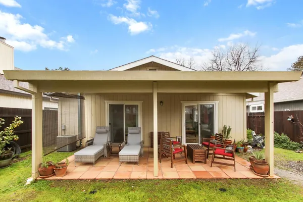 a view of a house with backyard porch and sitting area