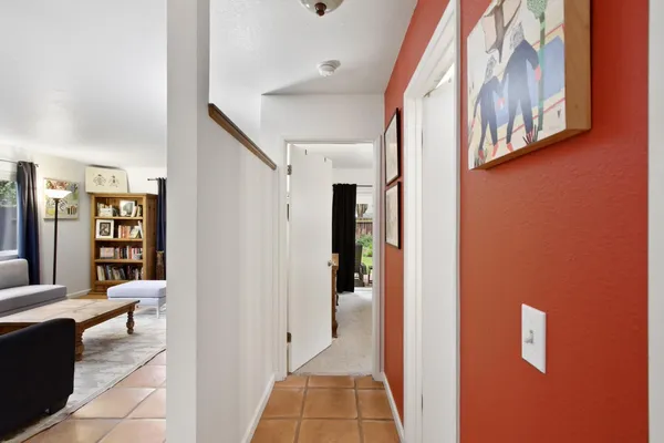 a view of a livingroom with furniture and staircase
