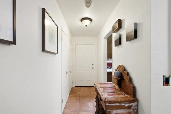a view of hallway with stairs and wooden floor