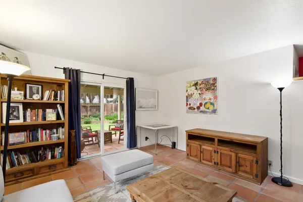 a living room with furniture and a book shelf
