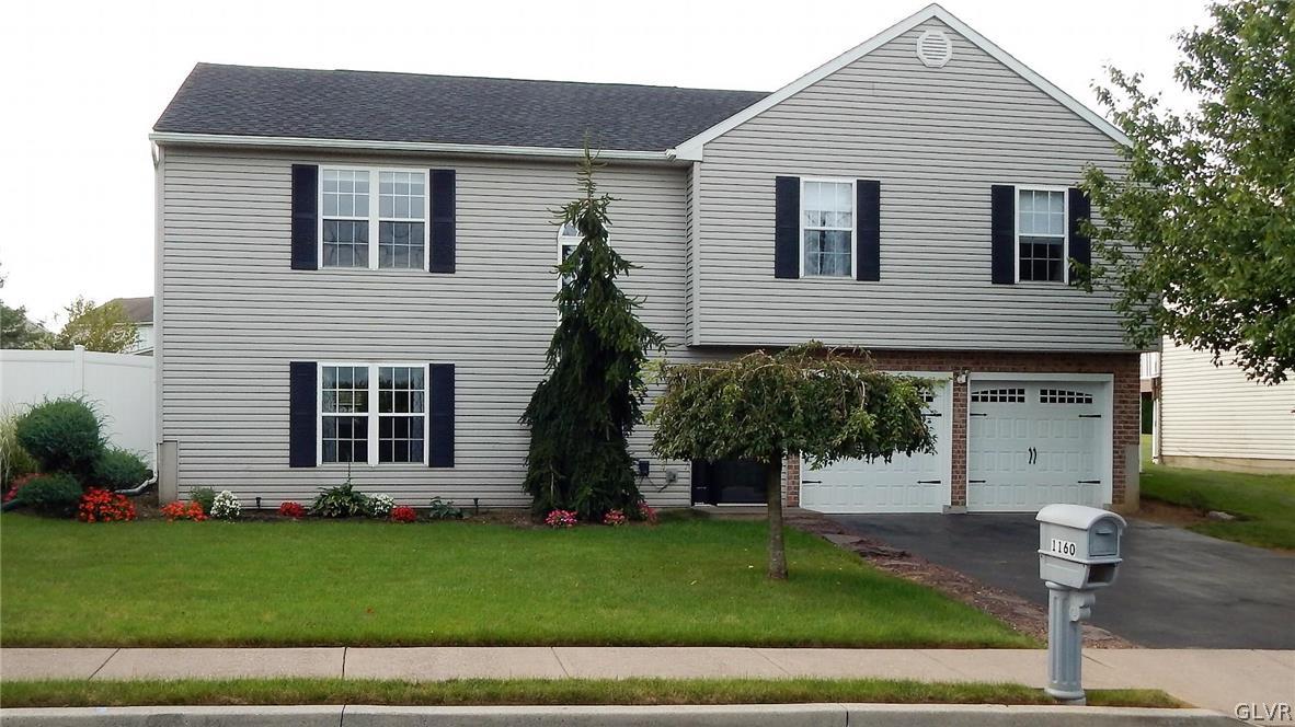 1160 Newlins Road West Easton, PA 18040 - Photo 1 of 12 a front view of a house with a garden and plants