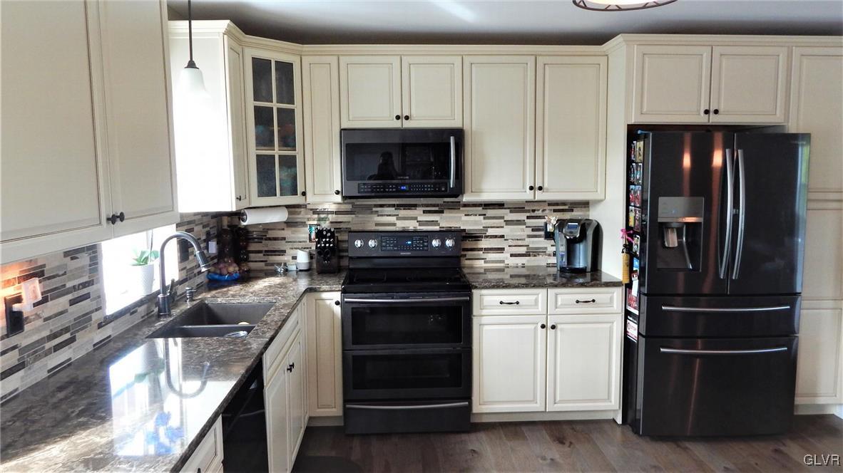 1160 Newlins Road West Easton, PA 18040 - Photo 4 of 12 a kitchen with white cabinets and stainless steel appliances