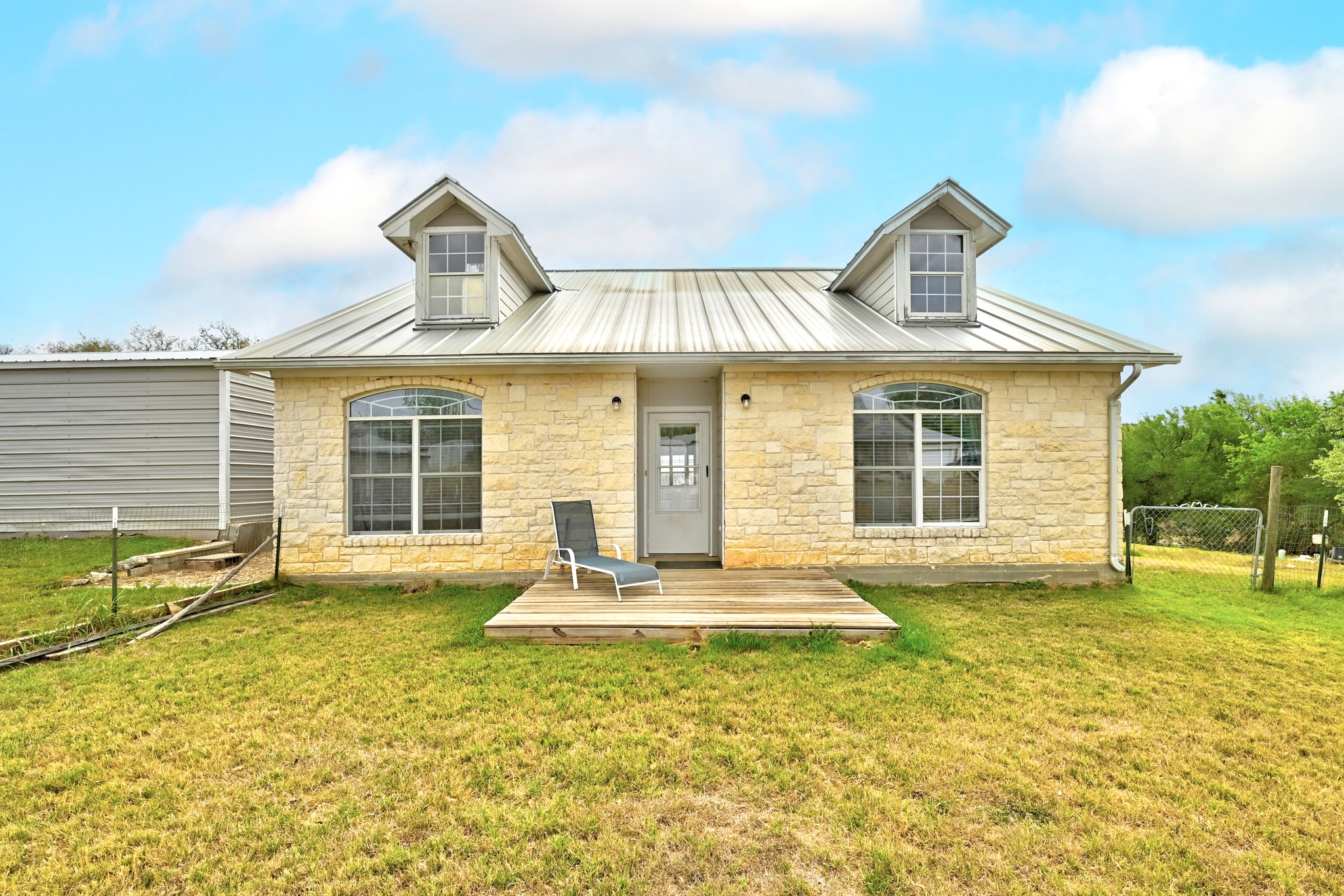 127 KLBJ Road Smithville, TX 78957 - Photo 10 of 39 a front view of a house with a yard