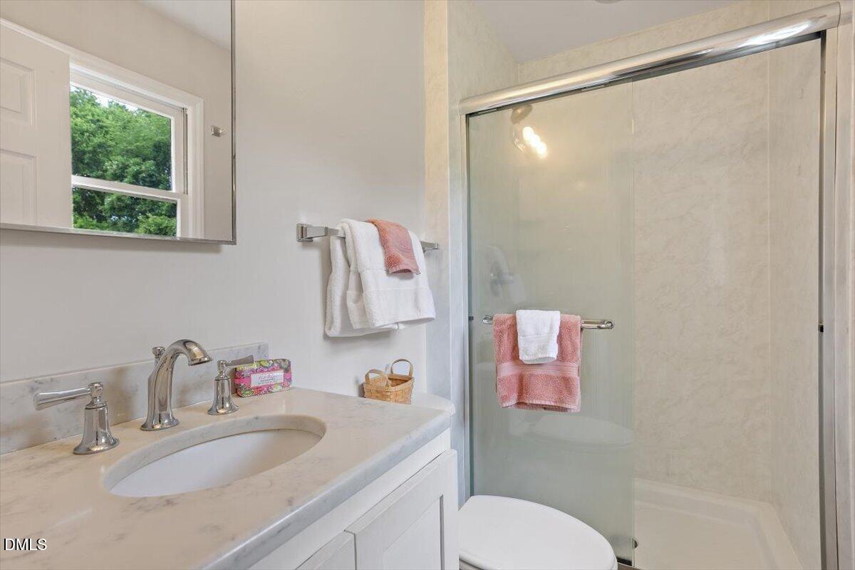 805 Rand Road Garner, NC 27529 - Photo 33 of 38 a bathroom with a sink toilet and a mirror
