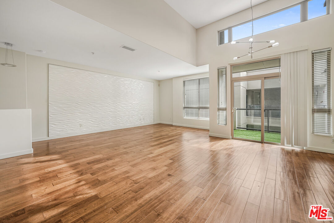 13044 Pacific Promenade, Unit 417 Playa Vista, CA 90094 - Photo 2 of 31 a view of empty room with wooden floor and fan