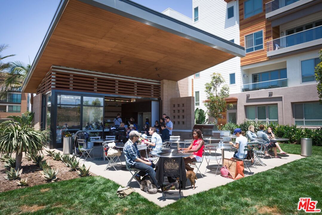 13044 Pacific Promenade, Unit 417 Playa Vista, CA 90094 - Photo 25 of 31 a view of a chairs and tables in the patio and a backyard