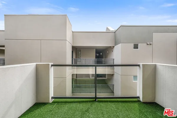 a kitchen with a refrigerator and white cabinets