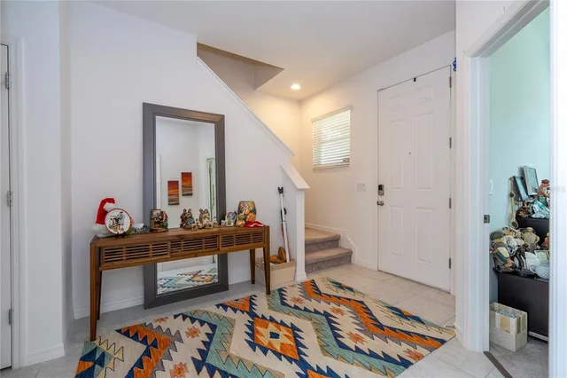 a living room with furniture and a baby crib