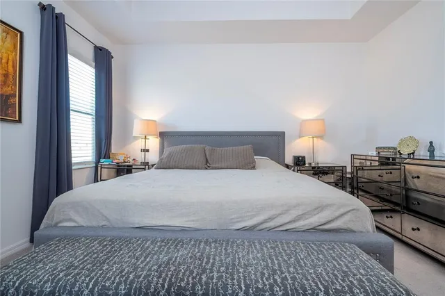 a bedroom with a bed and window