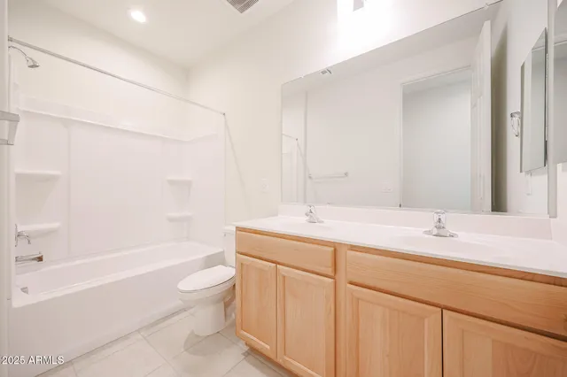 a bathroom with a granite countertop sink a toilet and bathtub
