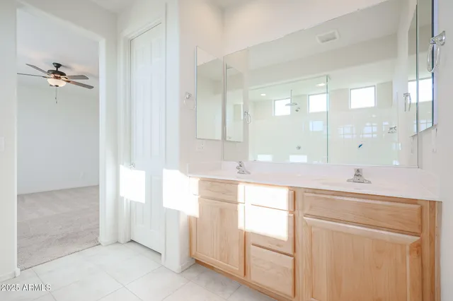 a spacious bathroom with a granite countertop sink a mirror and a