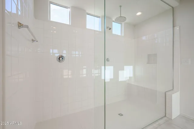 a bathroom with a glass shower door and a sink