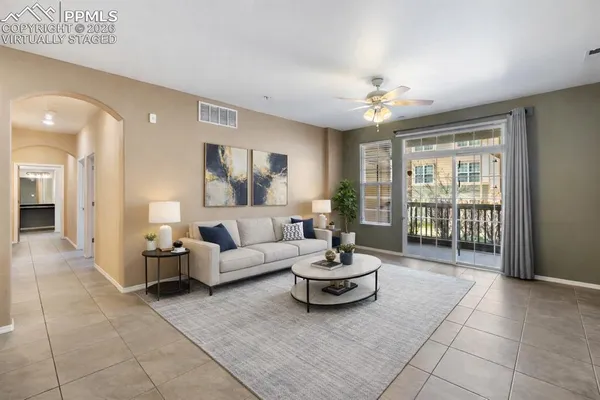 a living room with furniture and a large window