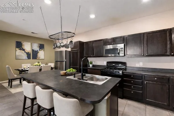 a kitchen with a counter space a sink cabinets and stainless steel appliances