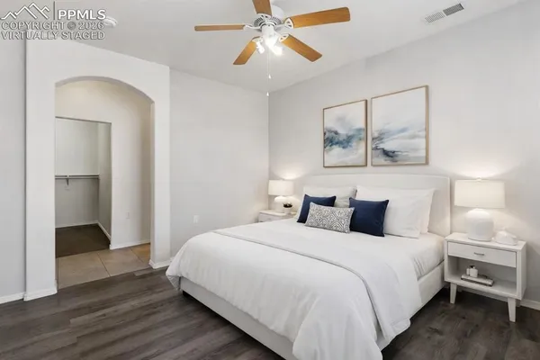 a bedroom with a bed and a chandelier