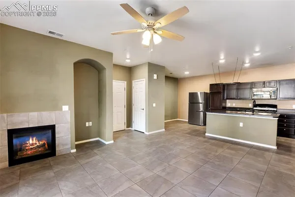 a view of kitchen with stainless steel appliances kitchen area and refrigerator