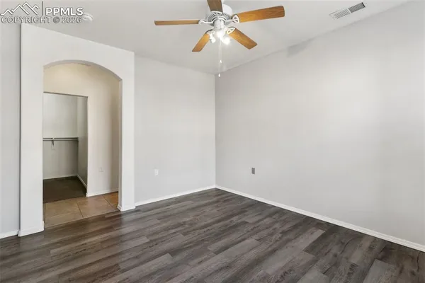 a view of an empty room with wooden floor