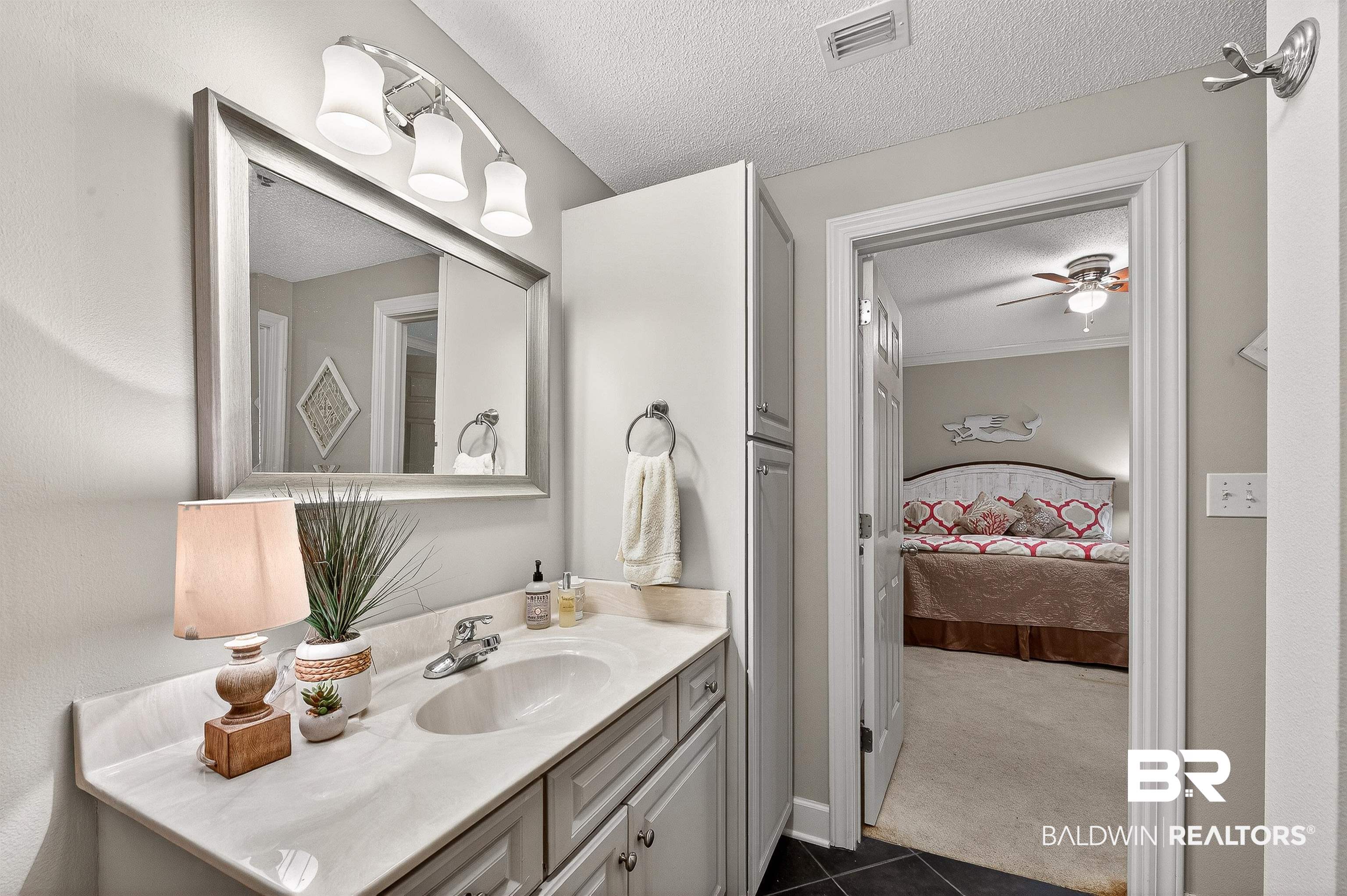 27582 Canal Road, Unit 2507 Orange Beach, AL 36561 - Photo 41 of 75 Ensuite bathroom featuring vanity, a textured ceiling, dark colored carpet, and a ceiling fan
