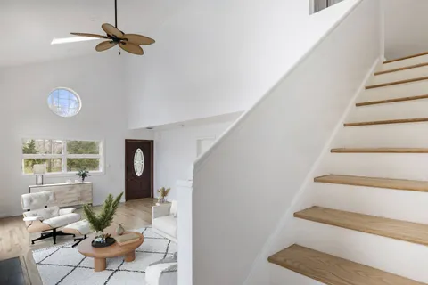 a view of an entryway with wooden floor and fan