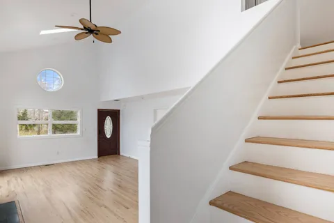 a bedroom with a bed and a painting on the wall