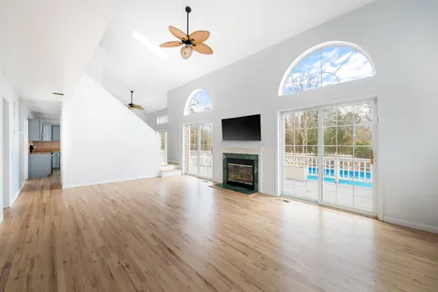 wooden floor in an empty room with a fireplace