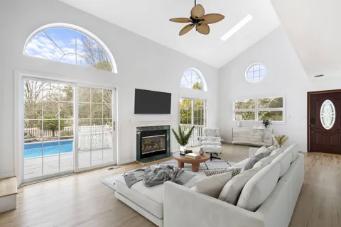 a living room with furniture a fireplace and a flat screen tv