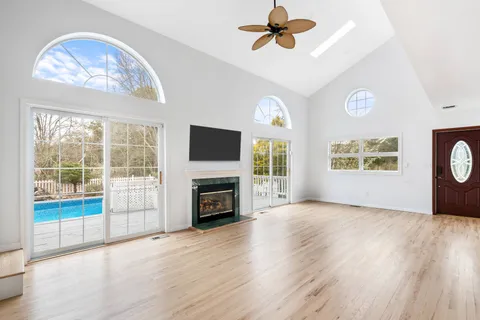 a view of livingroom with window fireplace and wooden floor