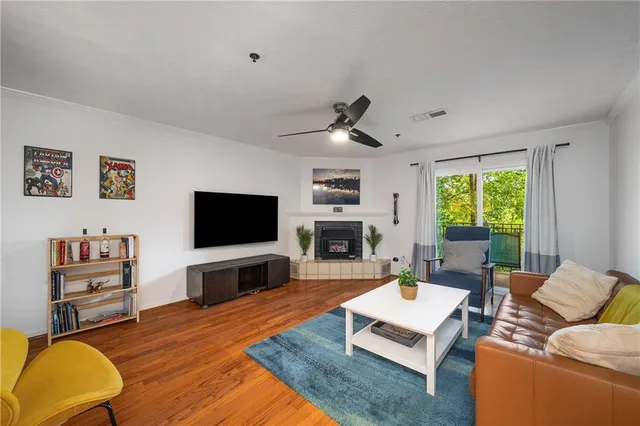 a living room with furniture flat screen tv and a fireplace