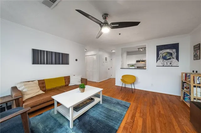 a living room with furniture and a wooden floor
