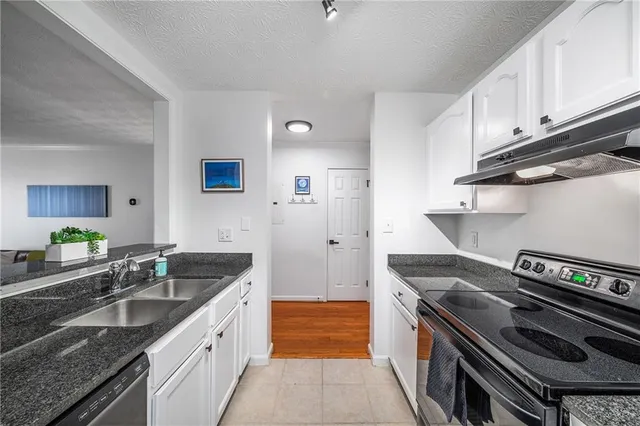 a kitchen with a sink stove and cabinets