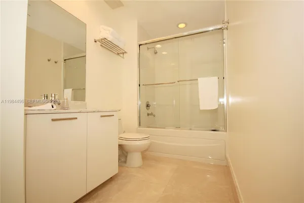 a bathroom with a toilet a sink and shower