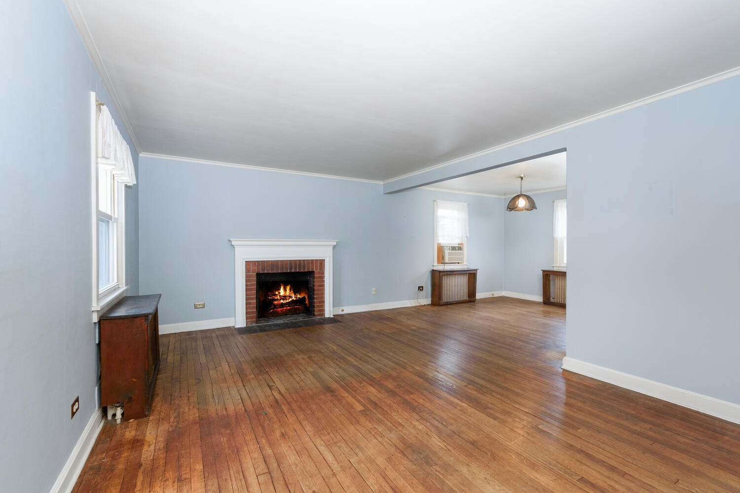 159 Hollow Tree Ridge Road Darien, CT 06820 - Photo 3 of 20 a view of an empty room with wooden floor fireplace and a window