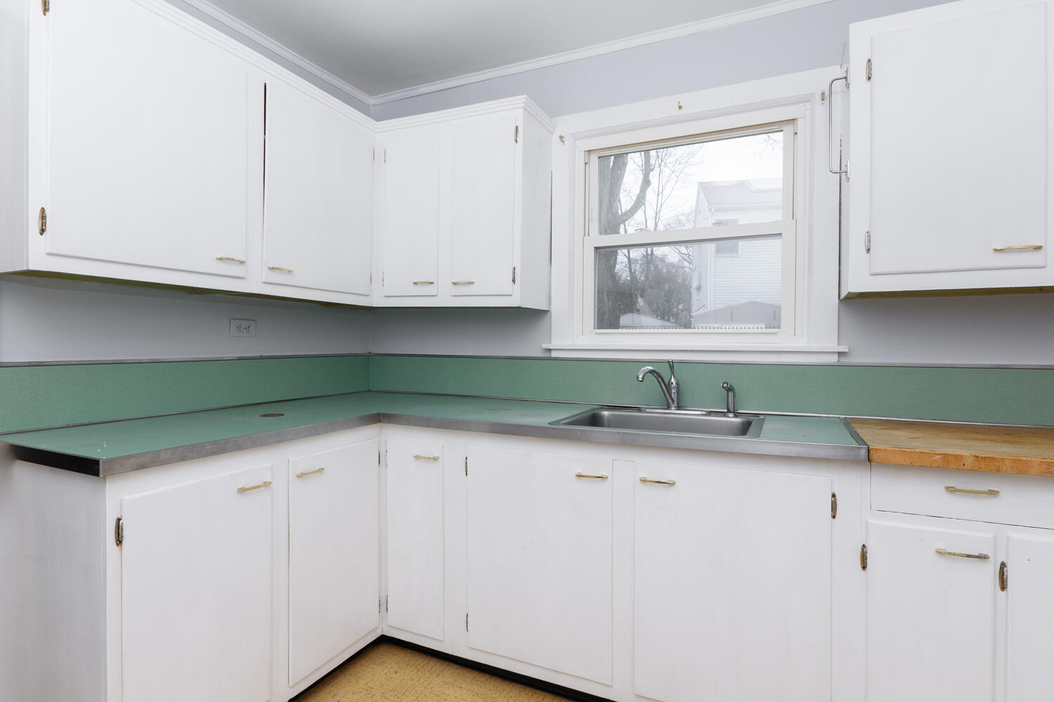 159 Hollow Tree Ridge Road Darien, CT 06820 - Photo 8 of 20 a kitchen with granite countertop white cabinets and window
