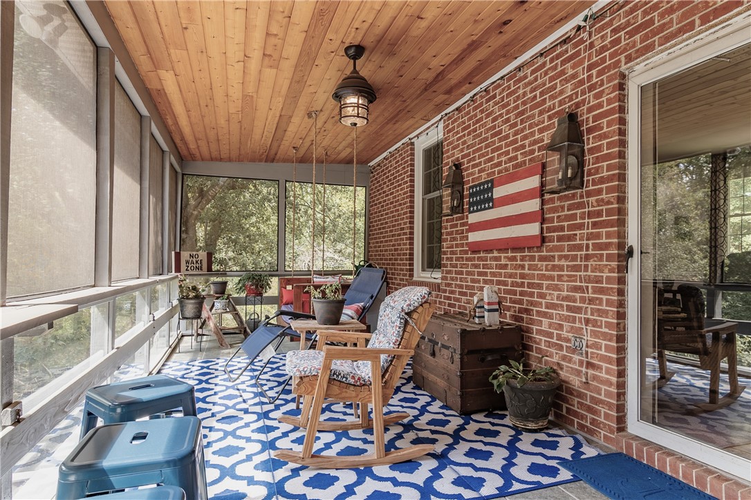 620 Seminole Point Road Fair Play, SC 29643 - Photo 25 of 50 Rich wood plank ceilings and classic brick walls highlight this inviting screened porch space.