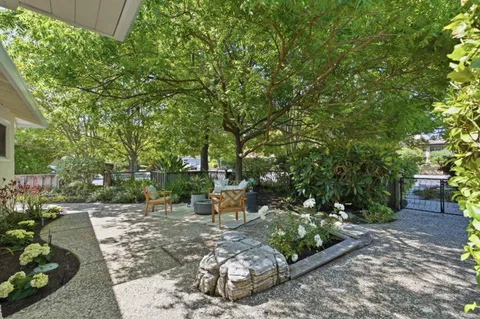 a view of a backyard with sitting area
