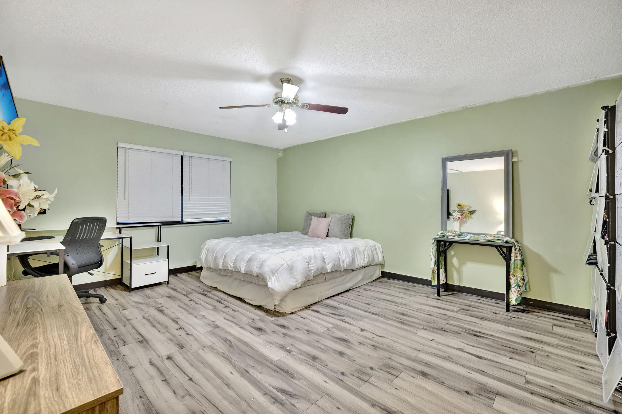 2080 Colonial Road, Unit 1 Fort Pierce, FL 34950 - Photo 14 of 21 a bedroom with a bed and wooden floor